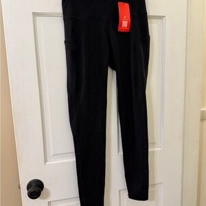 TGP- The Gym People. NWT. Sleek Black Women's Leggings with convenient pockets.